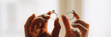 Hands holding signet rings toward the light