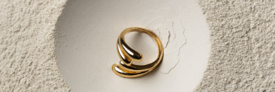 Gold statement ring on a textured surface